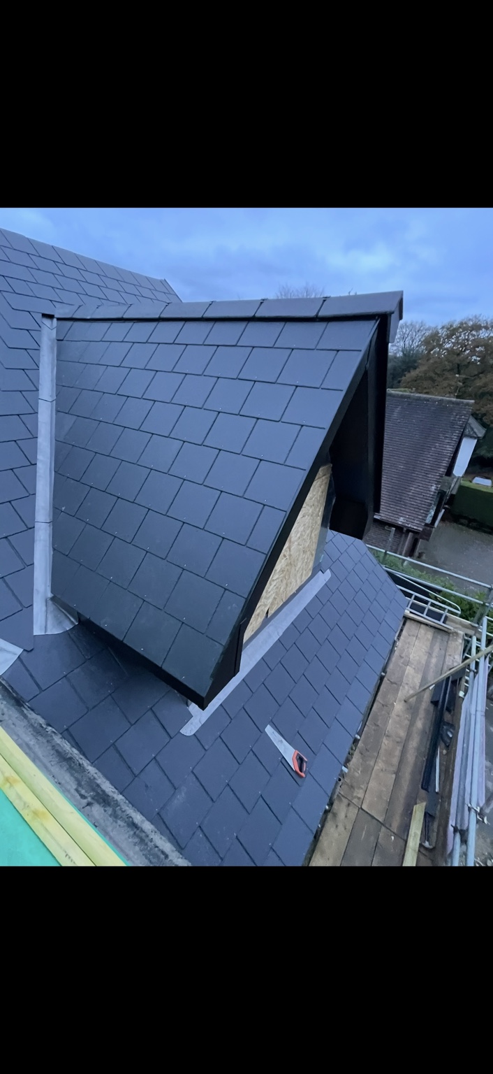 Roofer working on tiled roof